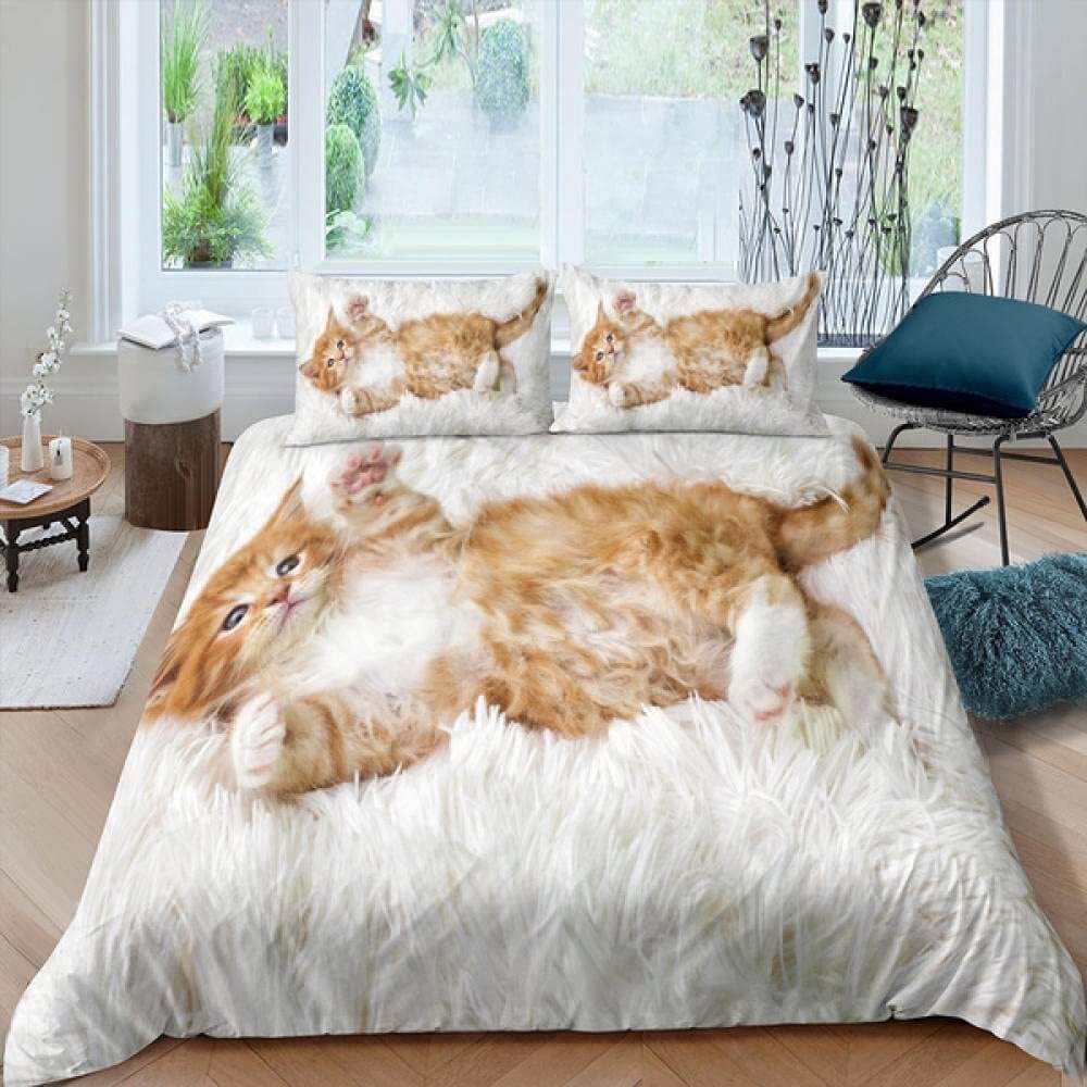 Cute kitten printed bedding set with quilt cover and pillows in a stylish bedroom setting.