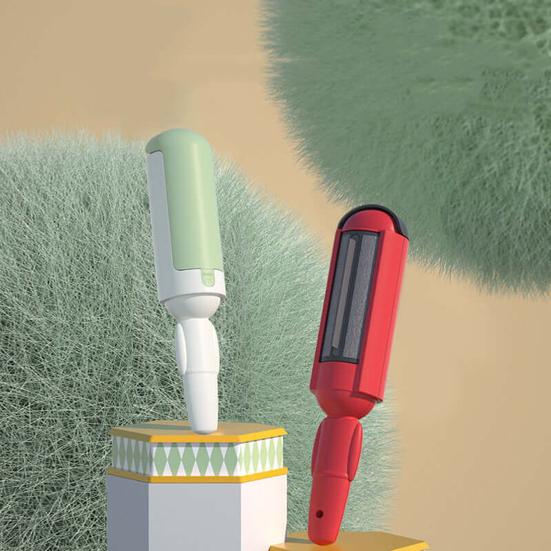 Pet hair roller in green and red colors displayed on pedestals against a soft background, ideal for quick pet hair removal.